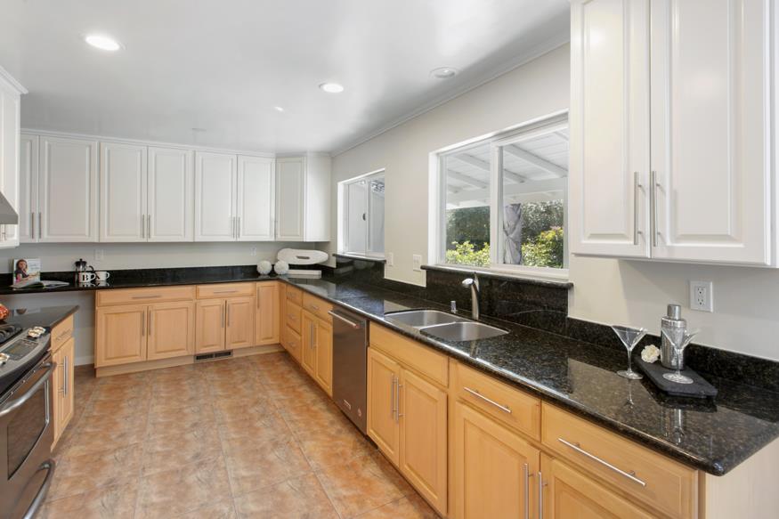 1055 Cascade Drive Menlo Park, CA 94025 - Photo 12 of 24 a large white kitchen with granite countertop white cabinets and a granite counter tops