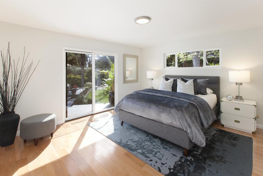 1055 Cascade Drive Menlo Park, CA 94025 - Photo 13 of 24 a spacious bedroom with a bed and glass window