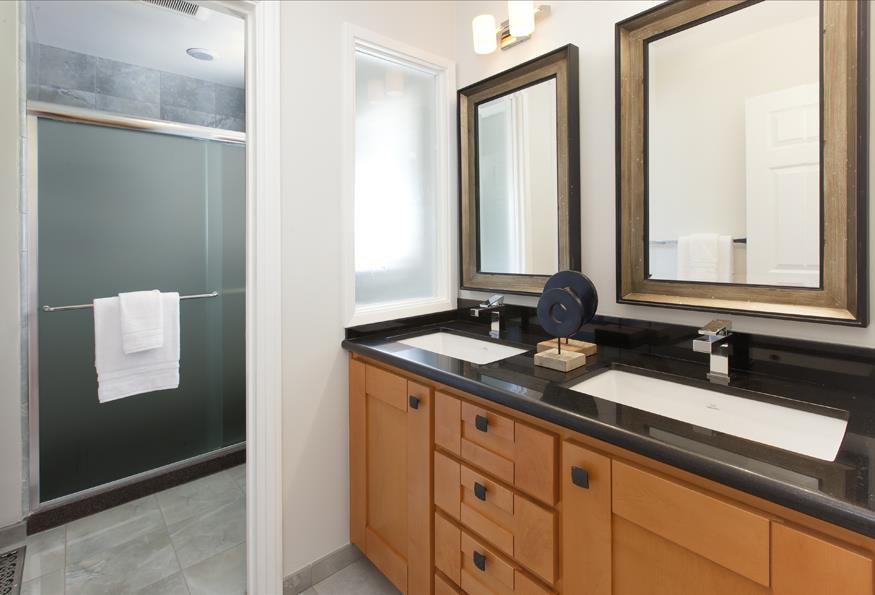 1055 Cascade Drive Menlo Park, CA 94025 - Photo 18 of 24 a bathroom with a double vanity sink and mirror