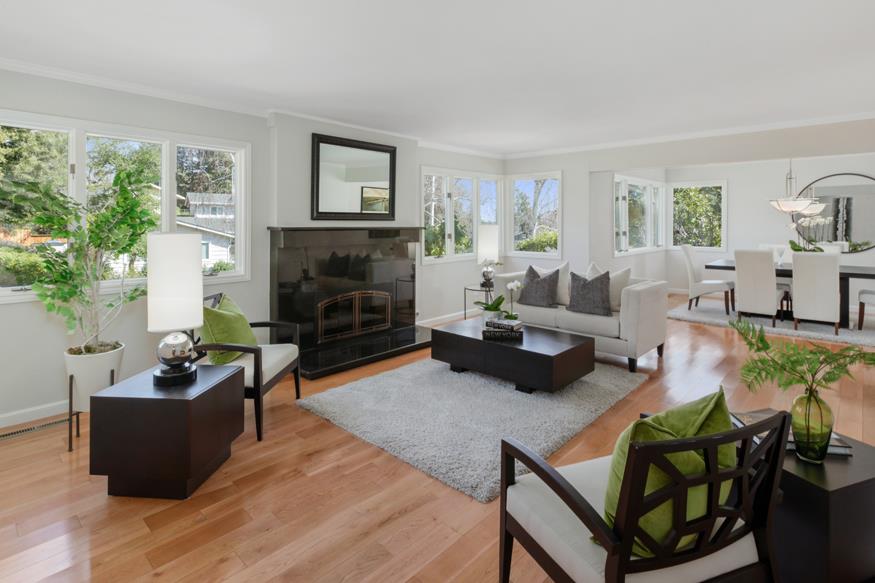 1055 Cascade Drive Menlo Park, CA 94025 - Photo 2 of 24 a living room with furniture potted plant a fireplace and a window