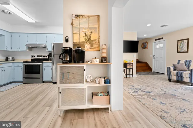a kitchen with a sink cabinets and dining table chair