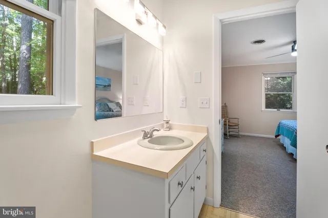 a bedroom with two beds and painting on the wall