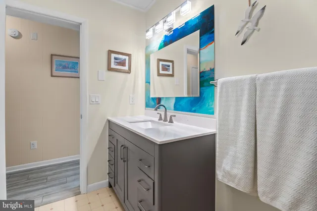 a bathroom with a sink a toilet and mirror