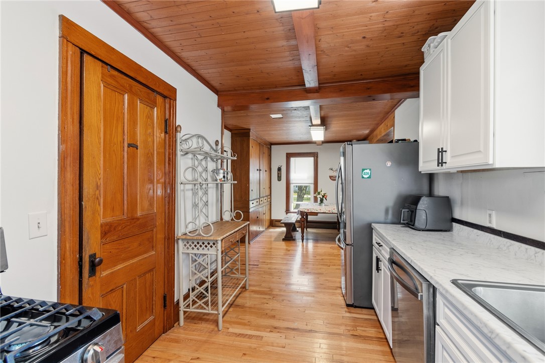 5443 Russell Road Marion, NY 14505 - Photo 10 of 48 The kitchen to the dining area- there’s a FULL bat