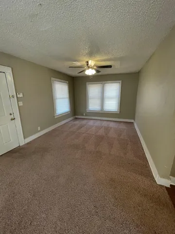 a view of empty room with window and fireplace
