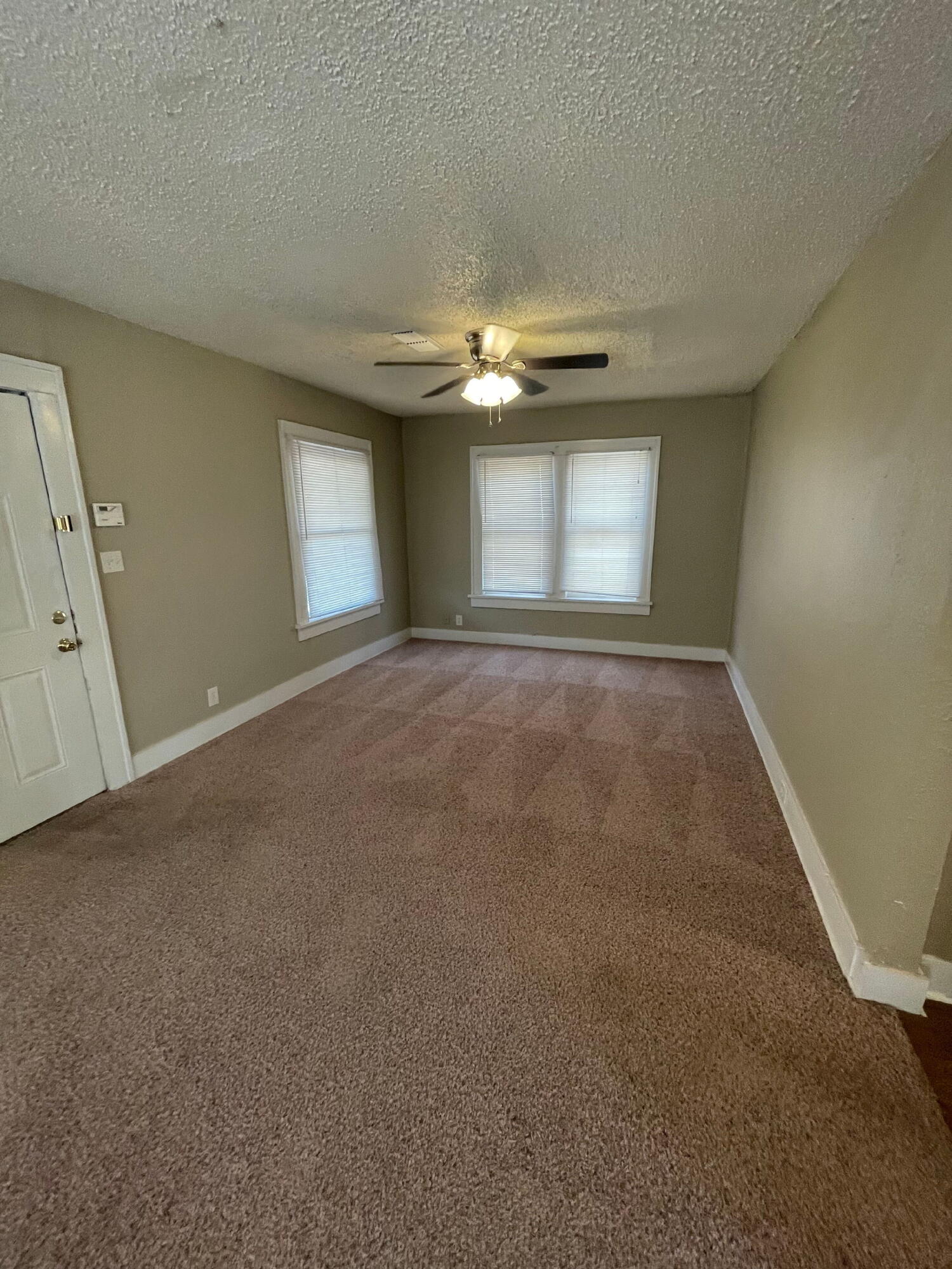 2111 14th Street Lubbock, TX 79401 - Photo 3 of 10 a view of empty room with window and fireplace
