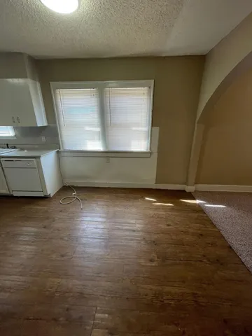 a view of room with window and wooden floor