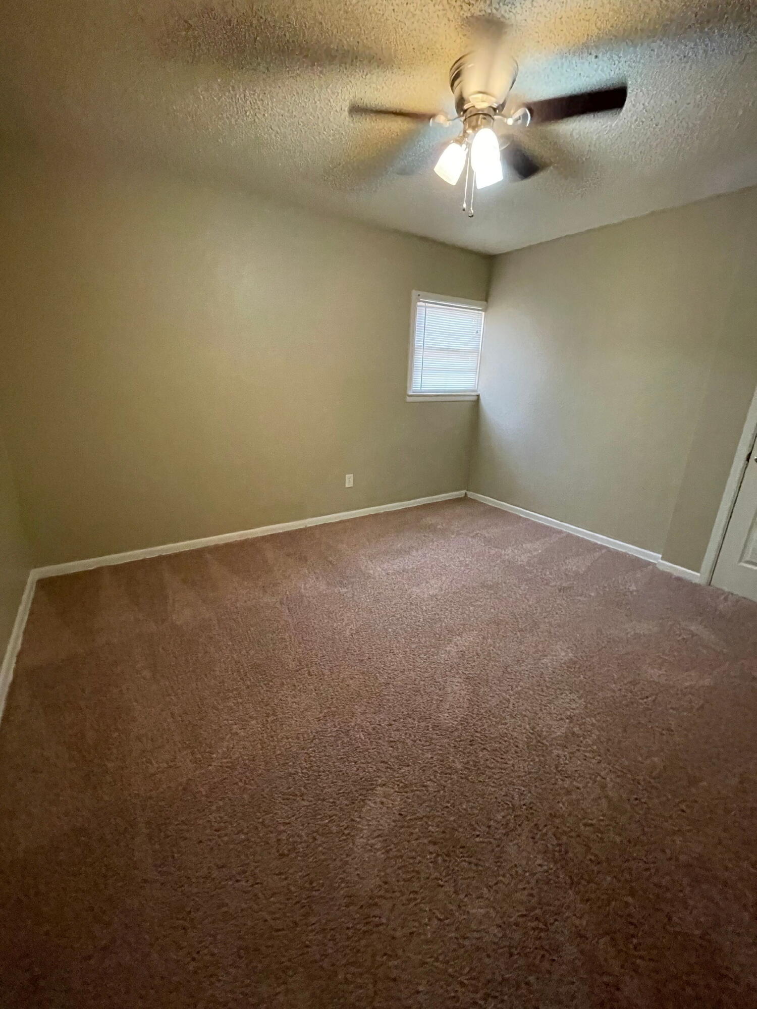 2111 14th Street Lubbock, TX 79401 - Photo 8 of 10 a view of an empty room with a window
