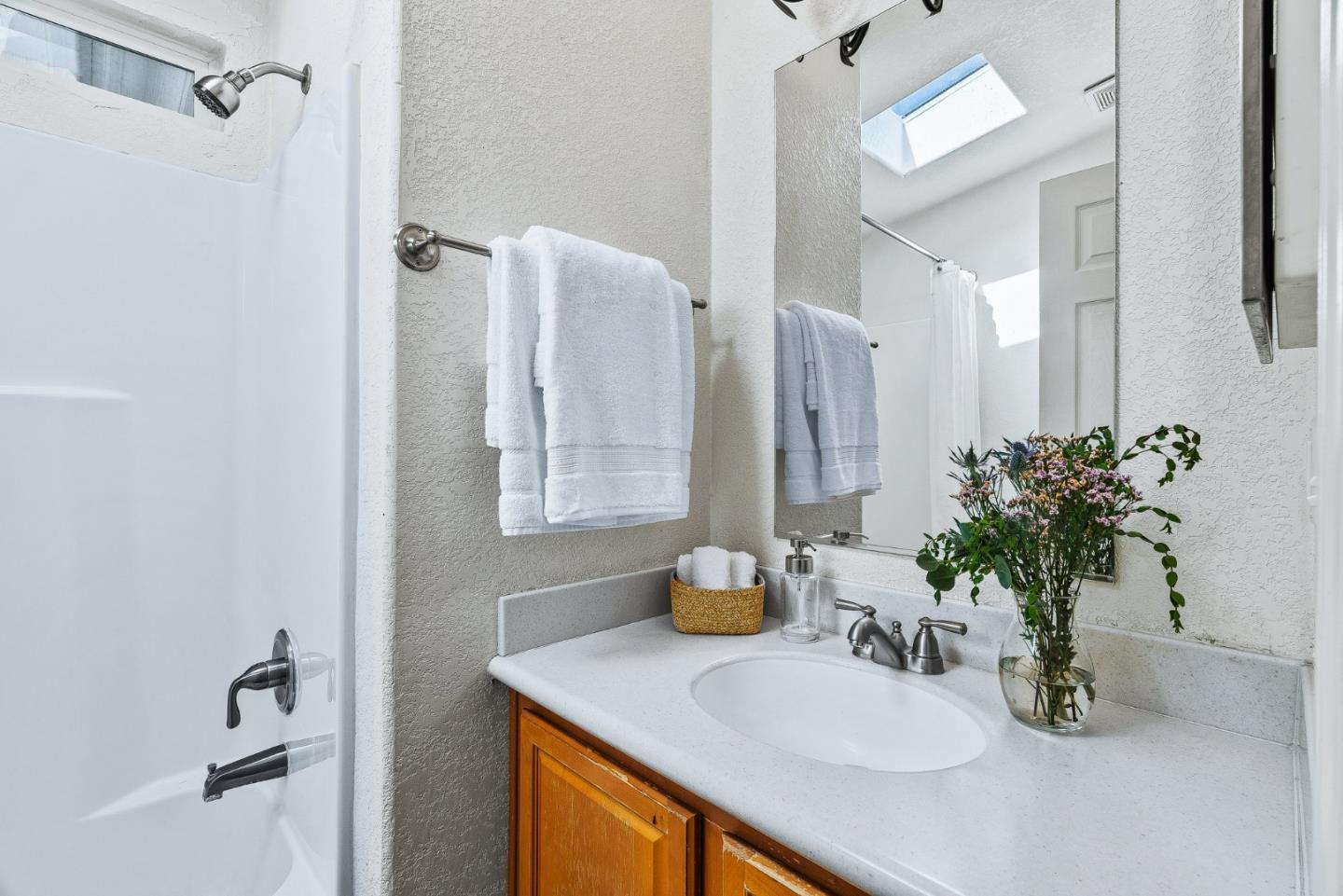 100 North Rodeo Gulch Road, Unit 74 Soquel, CA 95073 - Photo 25 of 40 a bathroom with a sink a mirror and a shower