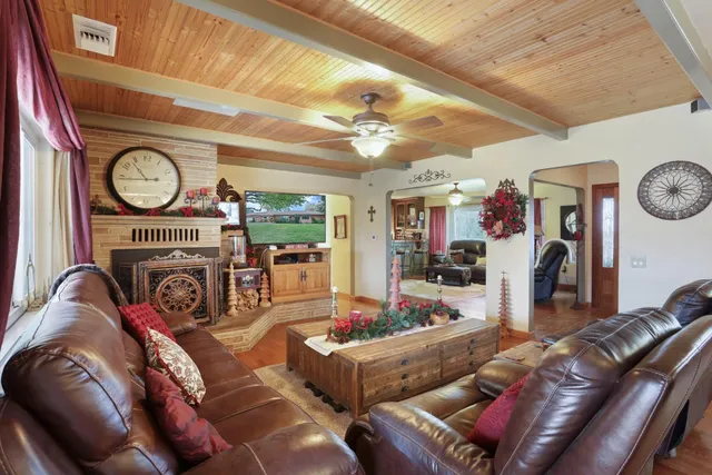 a kitchen with stainless steel appliances granite countertop a sink a stove and a wooden cabinets