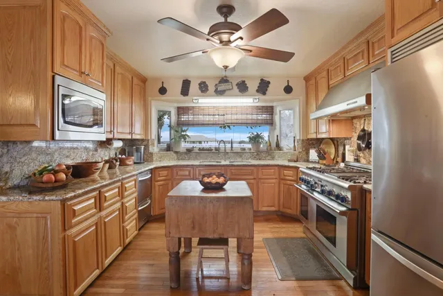 a stove top oven sitting inside of a kitchen