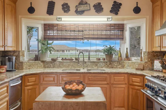 a kitchen with stainless steel appliances granite countertop a stove and a sink