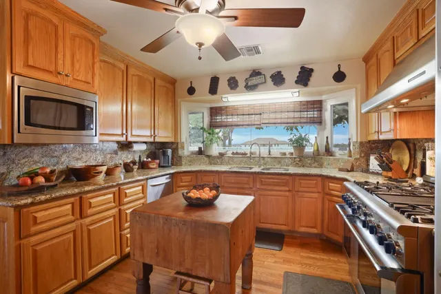 a view of a dining room with furniture a chandelier and wooden floor