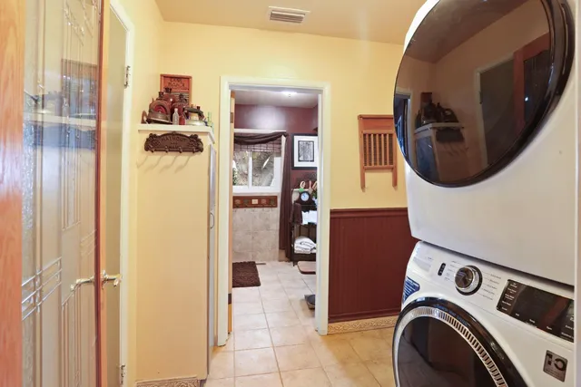 a view of a kitchen area with granite countertop lots of wooden cabinets