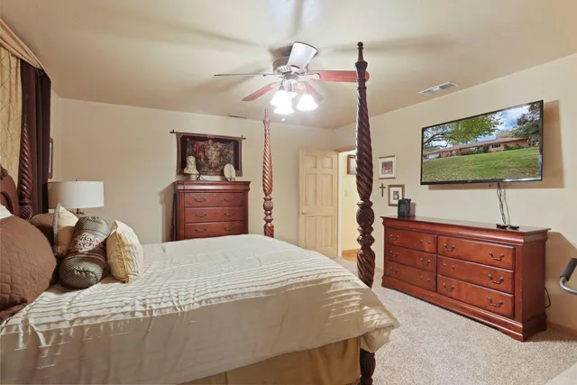 a view of a swimming pool with a table and chairs under an umbrella