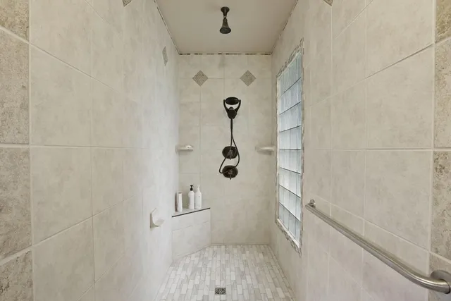 a view of a house with a big yard and large trees