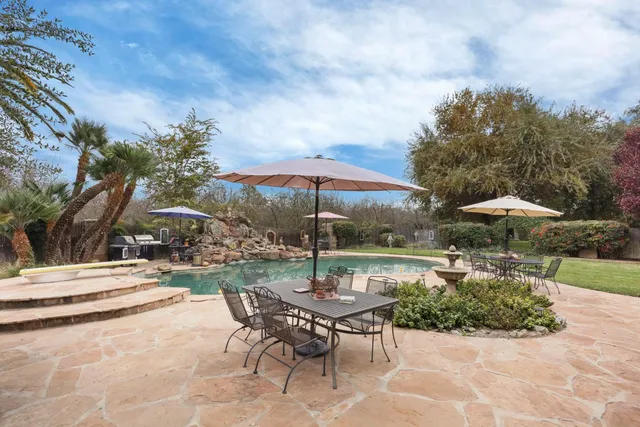 an aerial view of a house with a swimming pool and outdoor space
