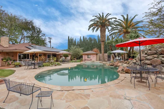 an aerial view of a residential houses with outdoor space