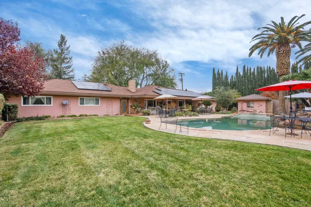 an aerial view of a house with a yard and lake view
