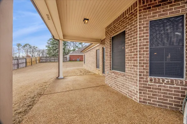 a view of house with outdoor space and wooden fence