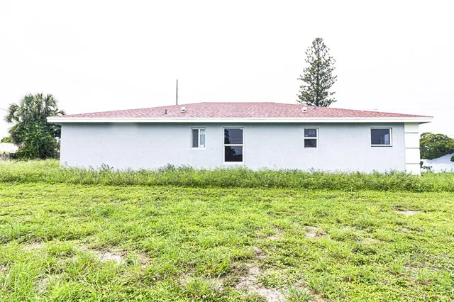 a front view of house with yard and trees