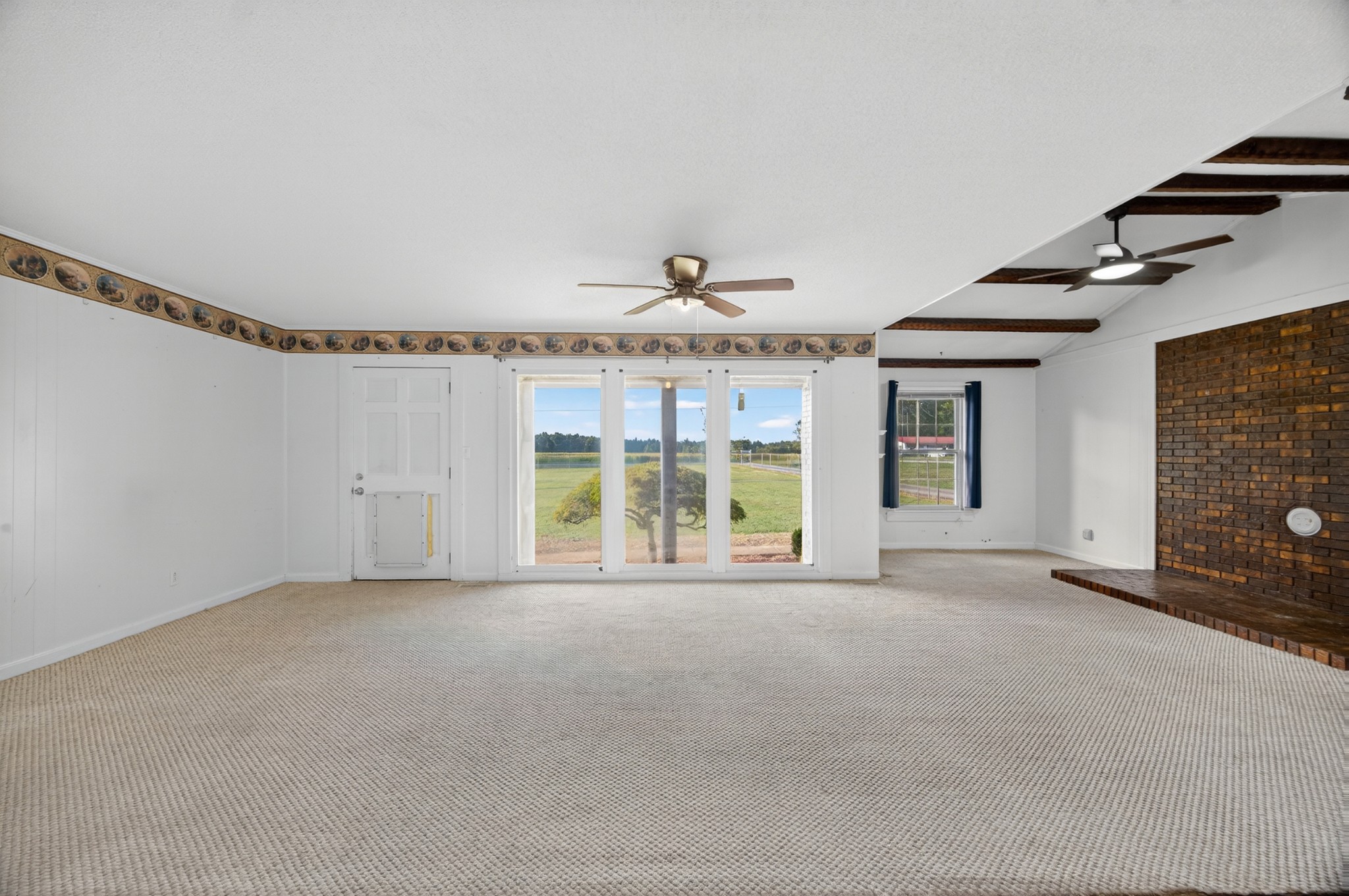 509 Limestone Road Elora, TN 37328 - Photo 7 of 41 a view of an empty room with a fireplace and a window