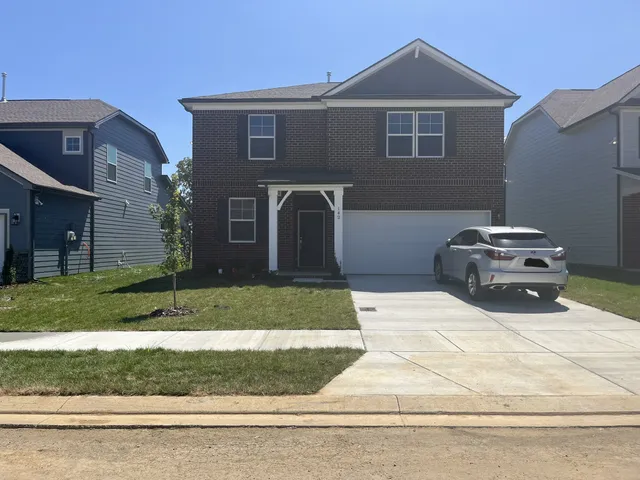 a front view of a house with a yard