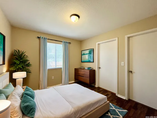 a bedroom with a bed and wooden floor