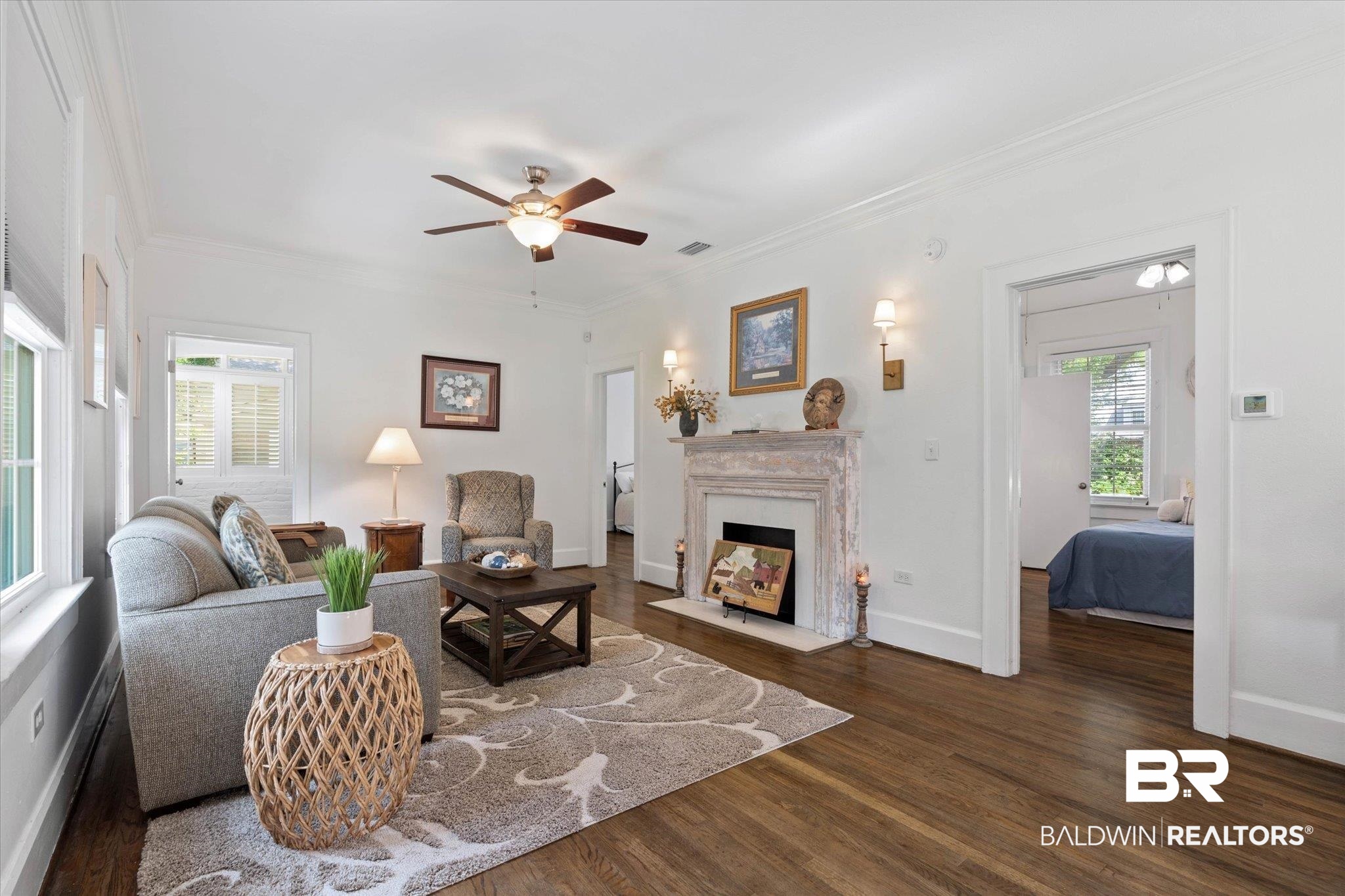 1910 Hunter Avenue Mobile, AL 36606 - Photo 4 of 21 Living area featuring wood finished floors, ceiling fan, ornamental molding, a high end fireplace, and baseboards