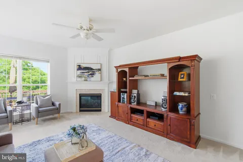 a living room with furniture fireplace and window