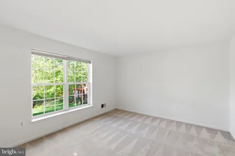 a view of a room with a large window and chandelier