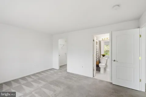 a bedroom with furniture and a large window