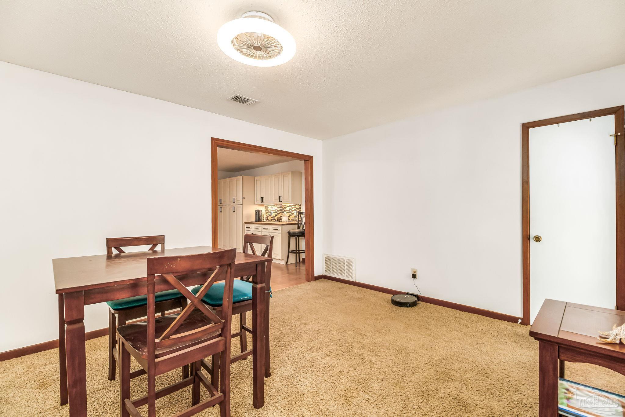 4640 Bessinger Lane Pace, FL 32571 - Photo 11 of 54 a dining room with furniture and a window