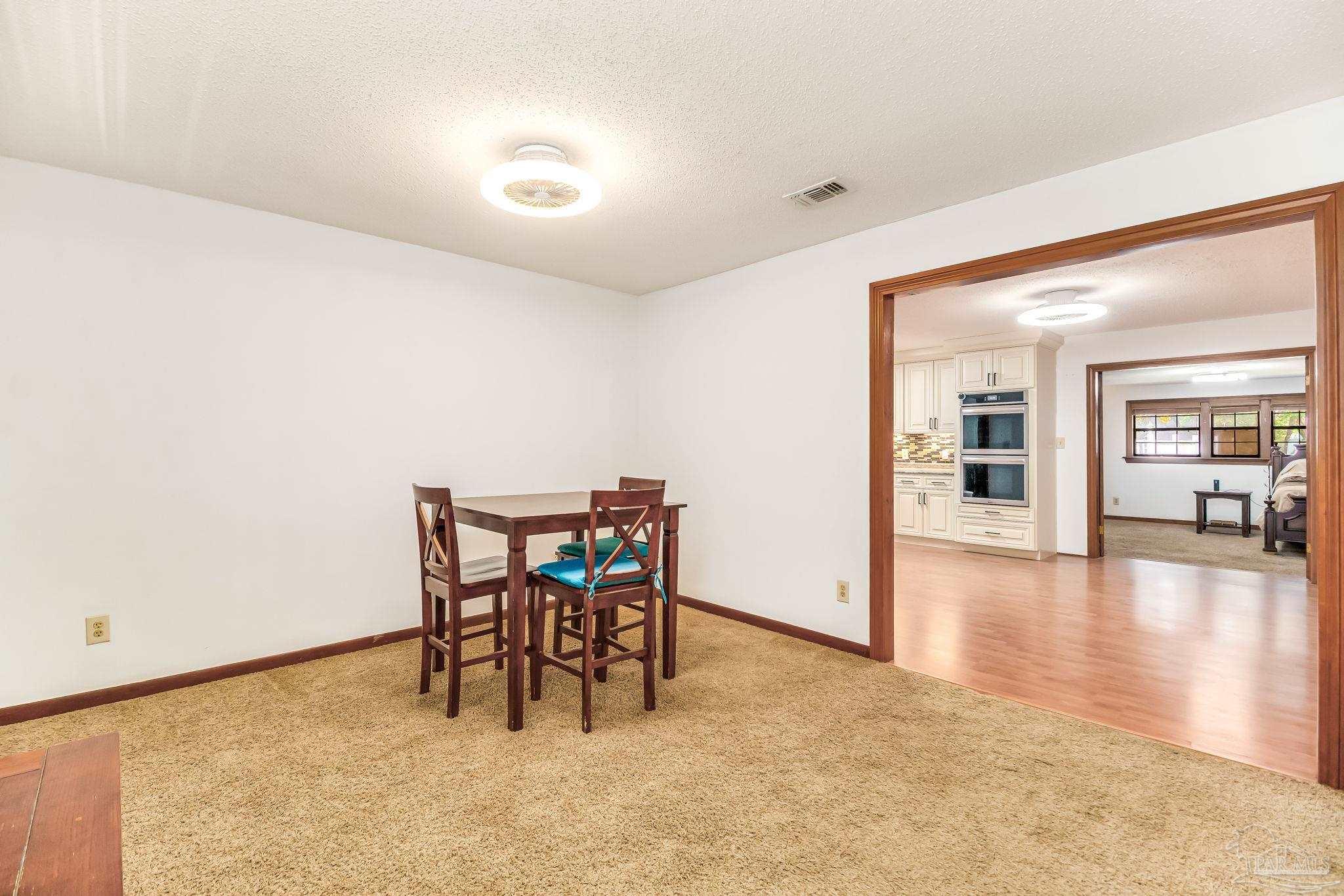 4640 Bessinger Lane Pace, FL 32571 - Photo 12 of 54 a view of a dining room with furniture and wooden floor