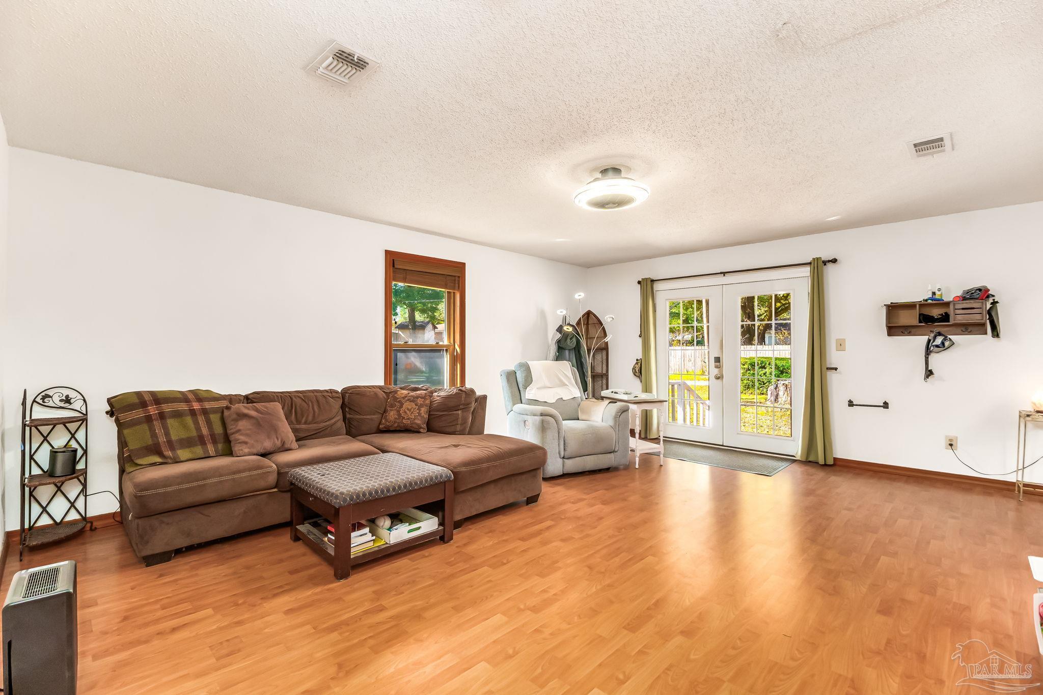 4640 Bessinger Lane Pace, FL 32571 - Photo 13 of 54 a living room with furniture and a wooden floor