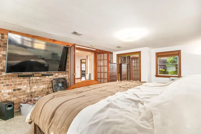 a bedroom with a flat screen tv and a bed