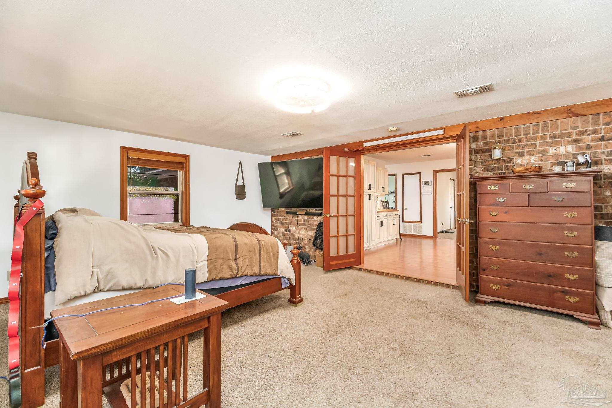 4640 Bessinger Lane Pace, FL 32571 - Photo 20 of 54 a spacious bedroom with a bed and a walk in closet
