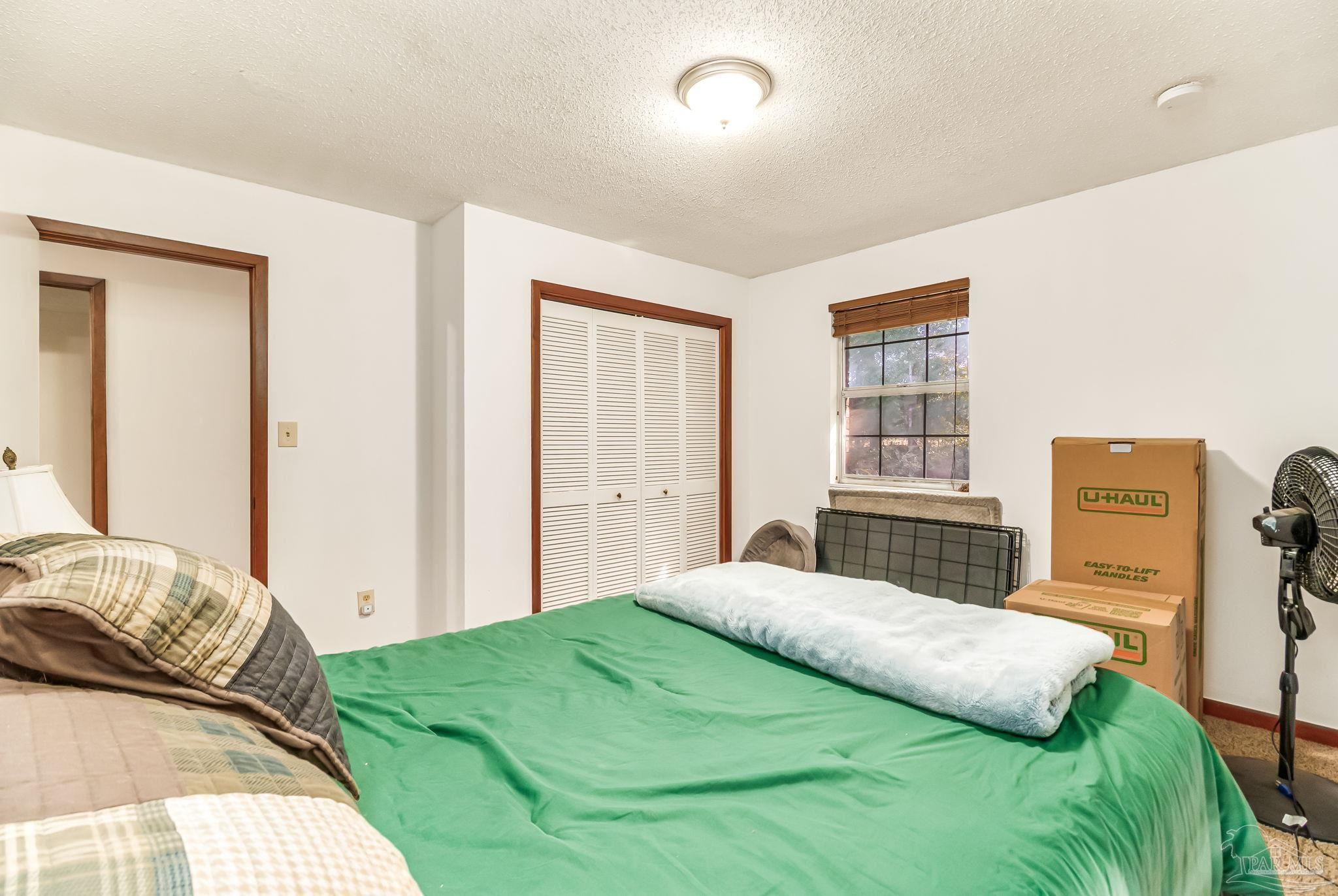 4640 Bessinger Lane Pace, FL 32571 - Photo 24 of 54 a bedroom with a bed and a window