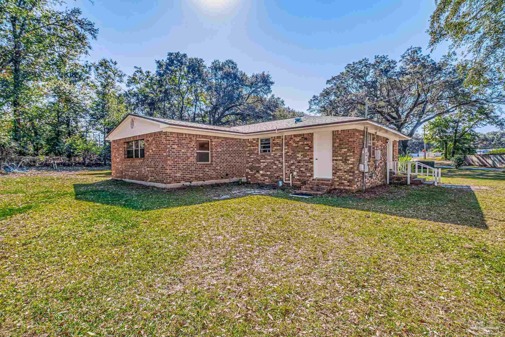 4640 Bessinger Lane Pace, FL 32571 - Photo 47 of 54 a view of a house with a yard potted plants and large tree