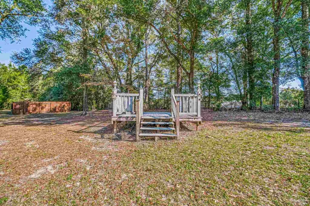 a view of a house with yard and entertaining space