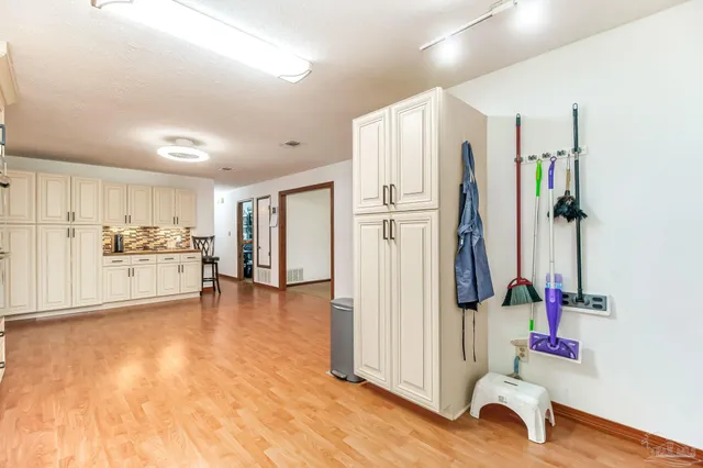 a view of a kitchen with refrigerator and wooden floor
