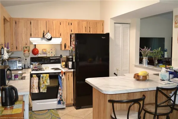 a kitchen with a appliances a refrigerator and a stove