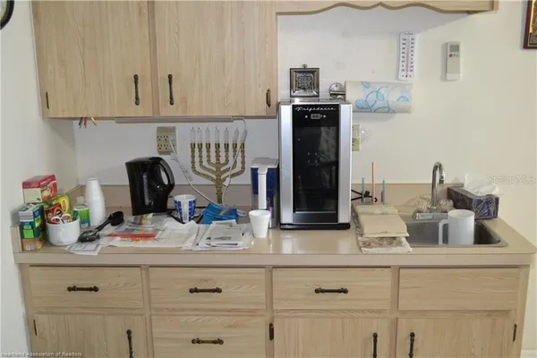 a kitchen with white cabinets and a sink
