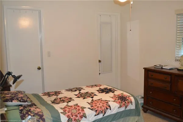 a bedroom with a bed and a dresser