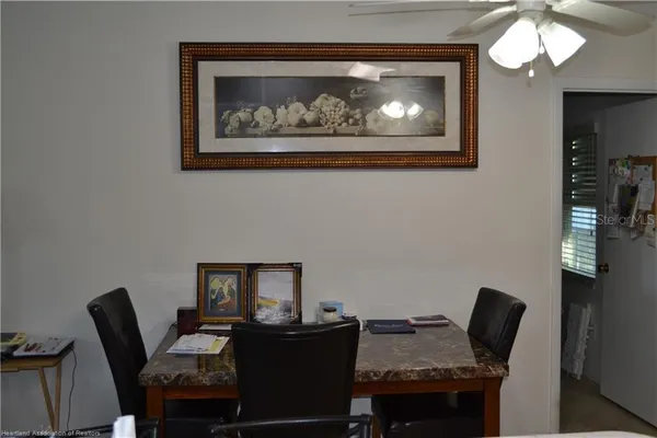 a dining room with furniture and wooden floor