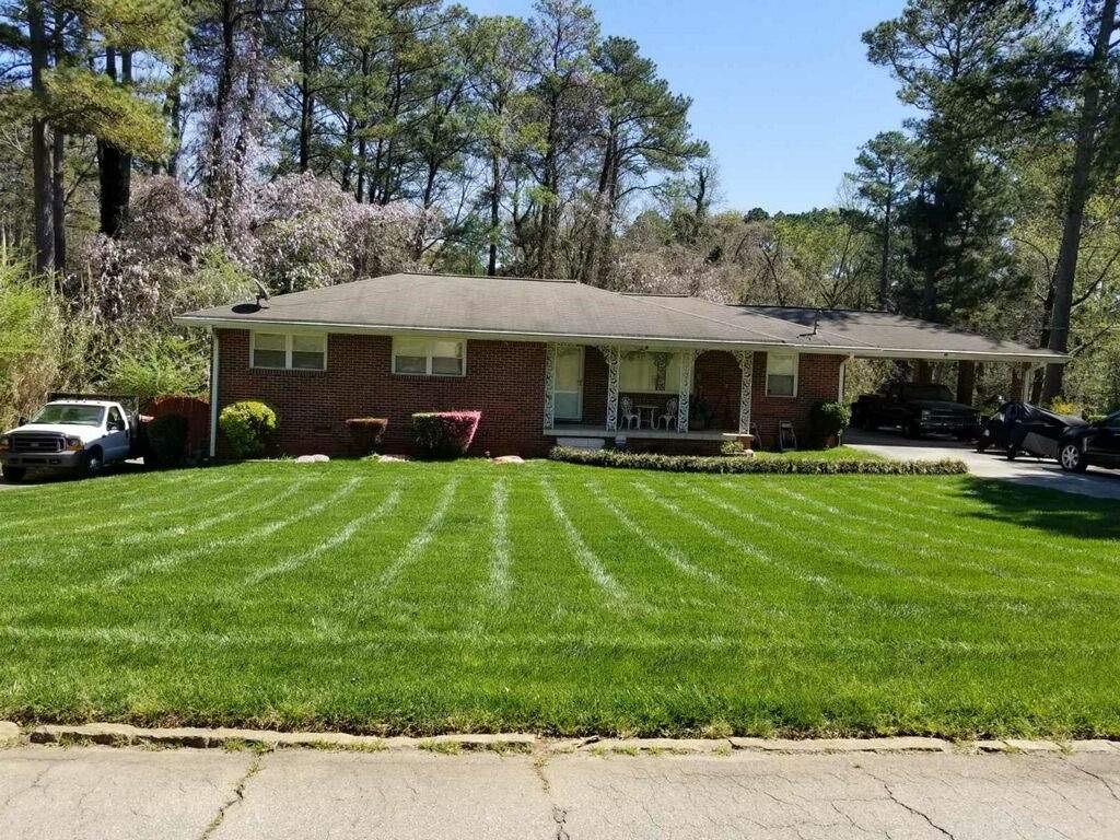 3058 Corbin Avenue Decatur, GA 30034 - Photo 1 of 1 a front view of a house with a garden and trees