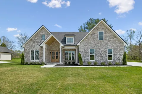 a front view of house with yard and green space