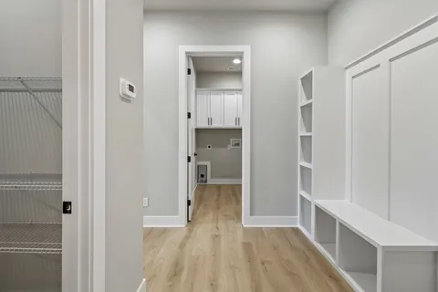 a view of hallway with wooden floor