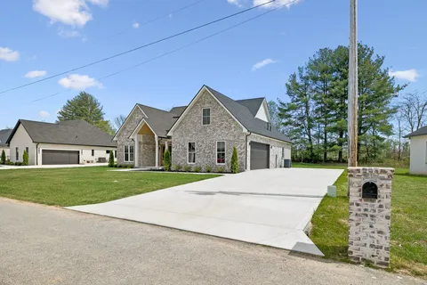 a front view of a house with a garden