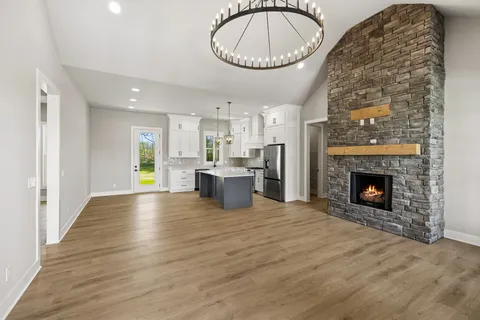 a view of a room with kitchen appliances and wooden floor